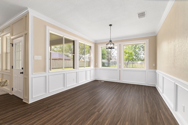 unfurnished dining area with visible vents, ornamental molding, plenty of natural light, and a decorative wall