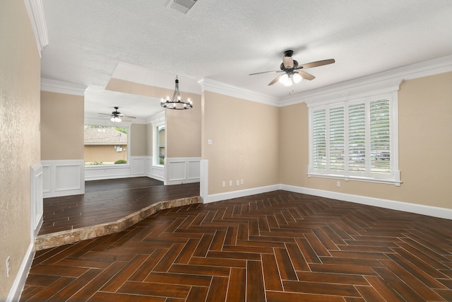 empty room featuring wainscoting, baseboards, ceiling fan with notable chandelier, and visible vents