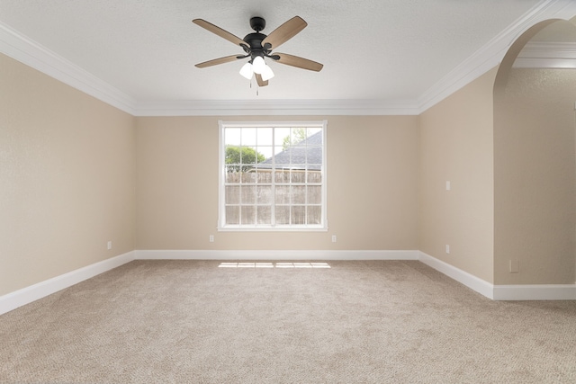 spare room with crown molding, a ceiling fan, and carpet