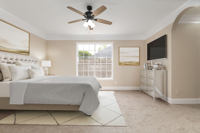 bedroom featuring arched walkways, ornamental molding, light carpet, and baseboards