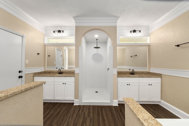 full bathroom with a textured ceiling, walk in shower, a textured wall, and wood finished floors