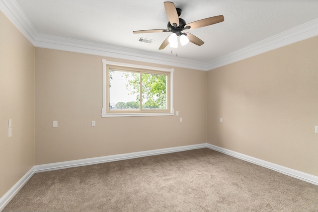 unfurnished room with visible vents, ornamental molding, carpet floors, and ceiling fan
