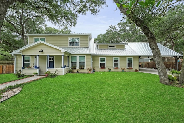 view of front of house featuring fence, an attached carport, and a front lawn