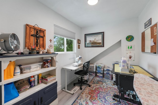 home office with baseboards and light wood finished floors