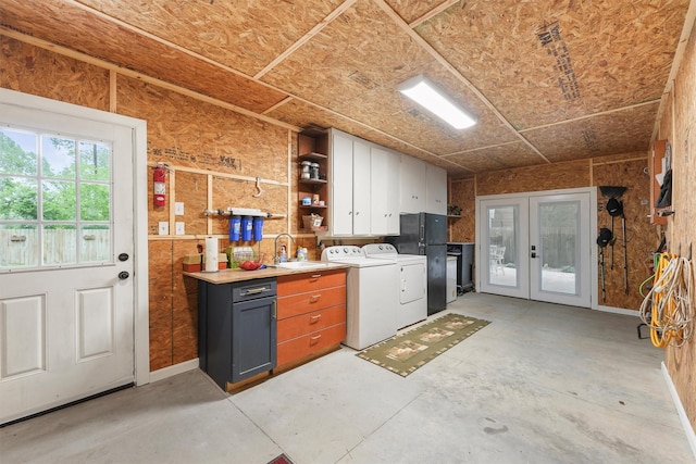 interior space with separate washer and dryer, a sink, french doors, and laundry area