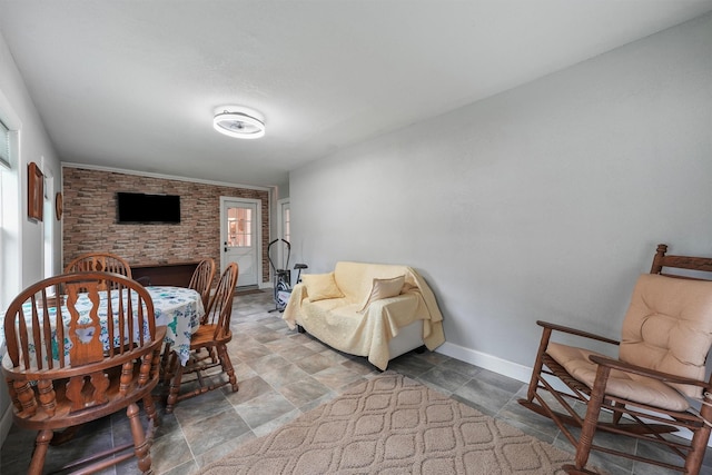 dining area featuring baseboards and stone finish flooring