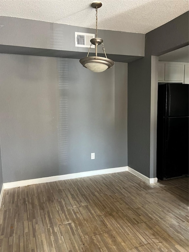 8100 Creekbend Dr Unit 153, Houston, TX 77071 - unfurnished dining area with wood finished floors, baseboards, and a textured ceiling