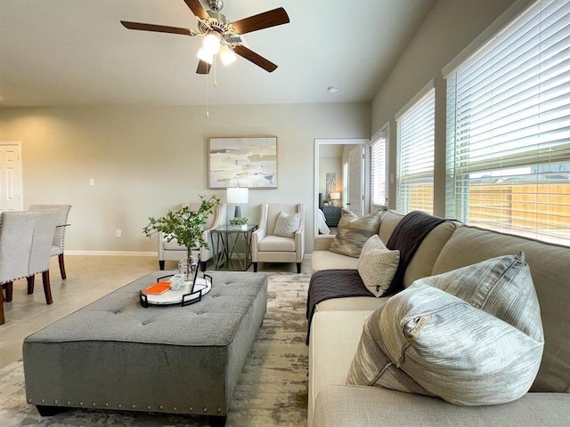 living area featuring ceiling fan and baseboards