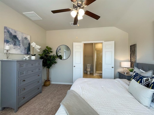 bedroom with baseboards, light colored carpet, visible vents, and ensuite bath