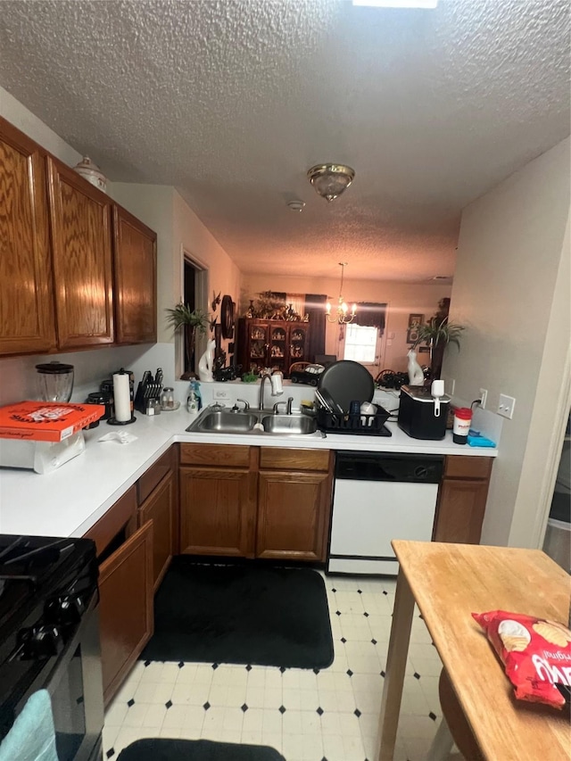 4710 Salina St, Houston, TX 77026 - kitchen featuring white dishwasher, a sink, light floors, a textured ceiling, and light countertops