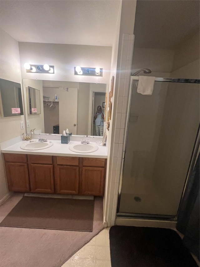 4710 Salina St, Houston, TX 77026 - bathroom featuring a stall shower, double vanity, and tile patterned floors