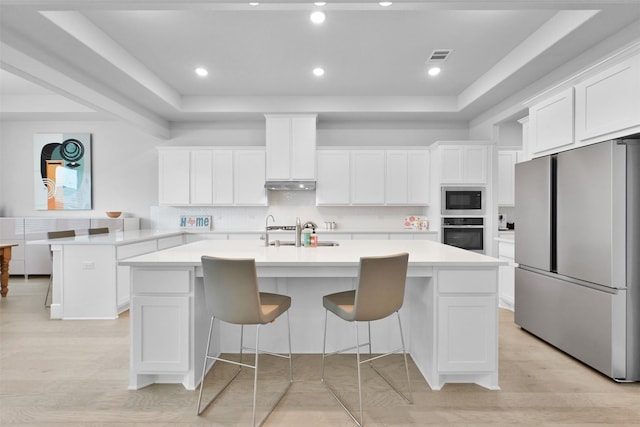 27954 Presley Park Dr, Spring, TX 77386 - kitchen with light countertops, appliances with stainless steel finishes, white cabinets, and a raised ceiling