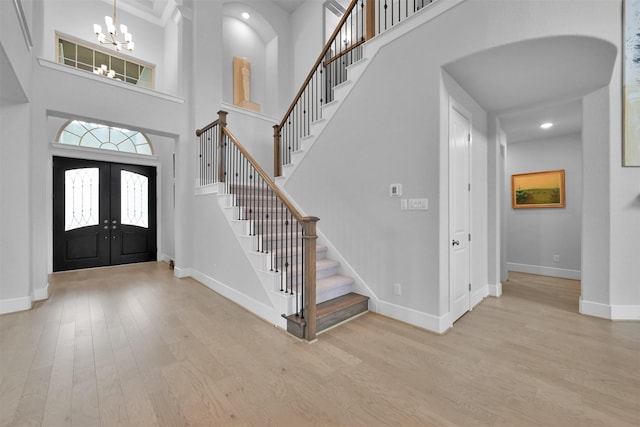 27954 Presley Park Dr, Spring, TX 77386 - foyer entrance with an inviting chandelier, french doors, baseboards, wood finished floors, and stairway