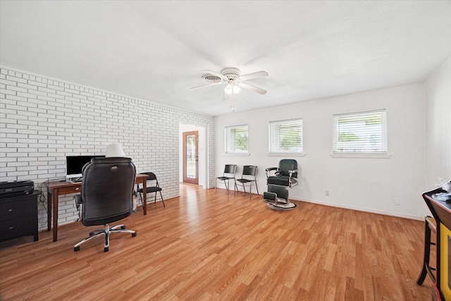 office with baseboards, a ceiling fan, brick wall, and light wood-style flooring