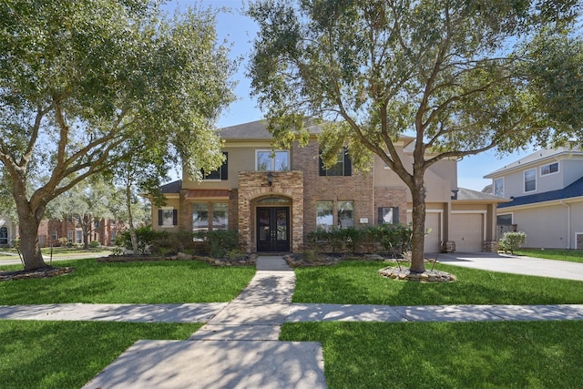 traditional-style house featuring an attached garage, stucco siding, a front yard, french doors, and driveway