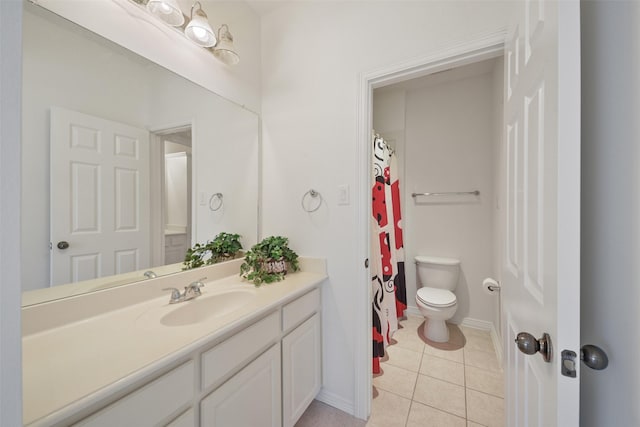 bathroom with vanity, tile patterned flooring, baseboards, and toilet