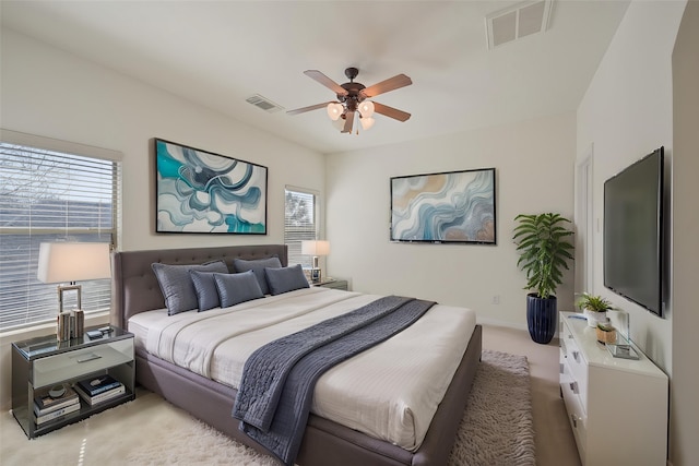 bedroom featuring visible vents, multiple windows, and light colored carpet
