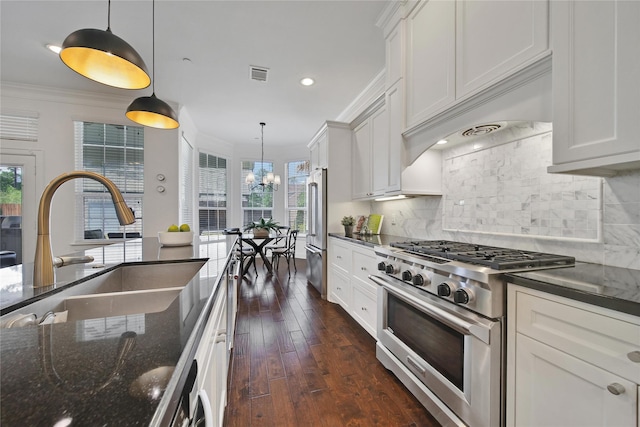 8322 Merlin Dr, Spring Valley Village, TX 77055 - kitchen featuring high quality appliances, crown molding, dark wood finished floors, tasteful backsplash, and white cabinetry