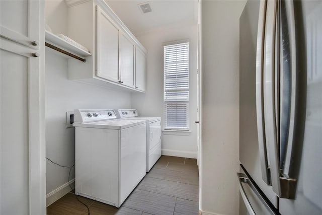 8322 Merlin Dr, Spring Valley Village, TX 77055 - washroom with washing machine and clothes dryer, baseboards, and cabinet space