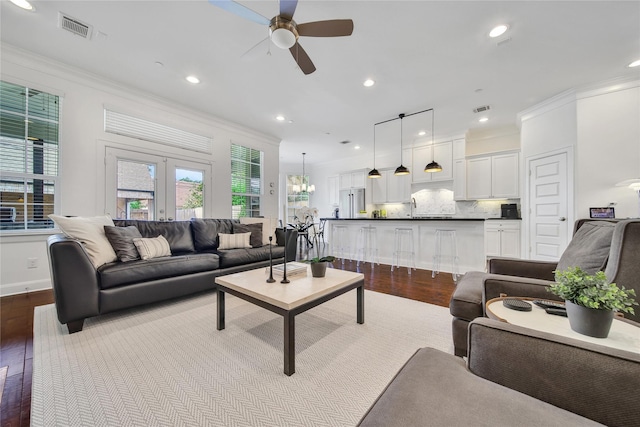 8322 Merlin Dr, Spring Valley Village, TX 77055 - living area featuring dark wood-style floors, ceiling fan, ornamental molding, recessed lighting, and french doors
