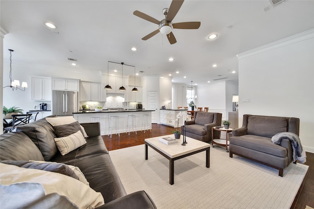 8322 Merlin Dr, Spring Valley Village, TX 77055 - living area with a ceiling fan, crown molding, dark wood-type flooring, recessed lighting, and a chandelier