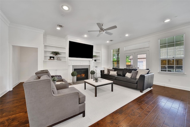 8322 Merlin Dr, Spring Valley Village, TX 77055 - living area featuring crown molding, ceiling fan, baseboards, wood finished floors, and a fireplace with flush hearth