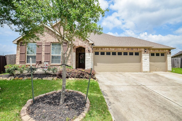single story home with a front yard, roof with shingles, a garage, fence, and concrete driveway