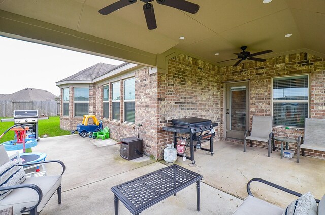 view of patio / terrace with fence, ceiling fan, and a grill