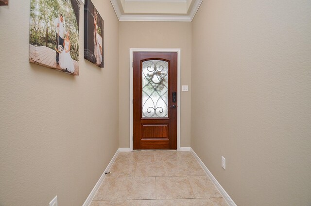 entryway with crown molding and baseboards