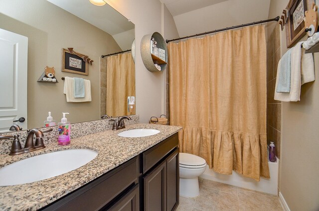full bath featuring double vanity, toilet, tile patterned floors, and a sink