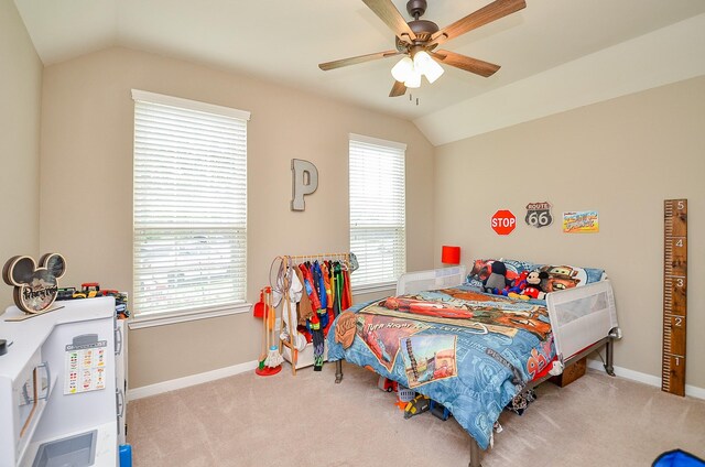 carpeted bedroom featuring a ceiling fan, baseboards, and vaulted ceiling
