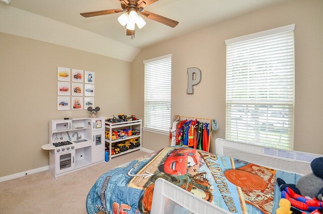 carpeted bedroom with baseboards, ceiling fan, and vaulted ceiling