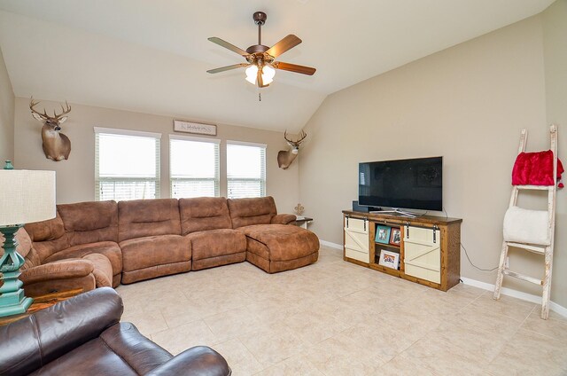 living area with a healthy amount of sunlight, baseboards, a ceiling fan, and lofted ceiling