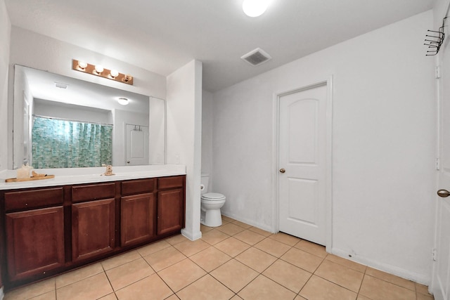 bathroom featuring toilet, visible vents, tile patterned flooring, and vanity