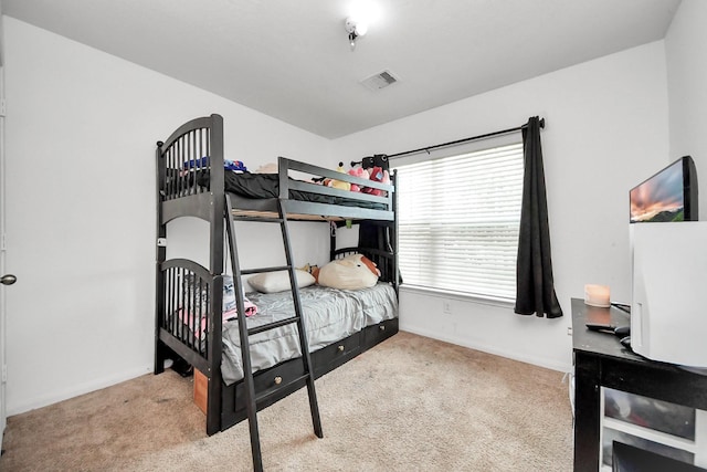 carpeted bedroom with baseboards and visible vents