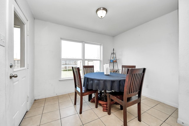 dining room with baseboards and light tile patterned flooring