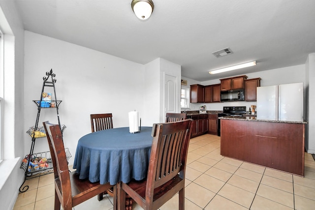dining space with visible vents and light tile patterned floors