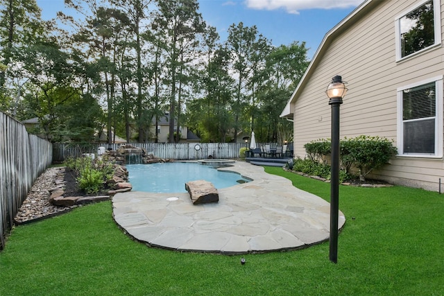view of swimming pool featuring a fenced backyard, a fenced in pool, a yard, and a patio