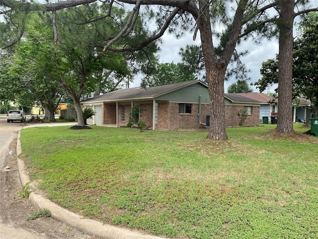 ranch-style home featuring brick siding and a front yard
