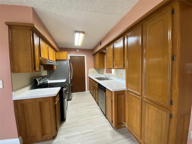 kitchen featuring a sink, appliances with stainless steel finishes, under cabinet range hood, and brown cabinets