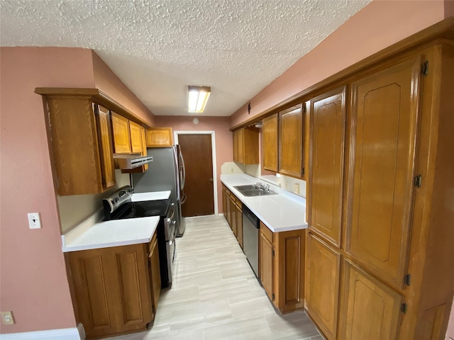 kitchen featuring light countertops, brown cabinetry, and stainless steel appliances