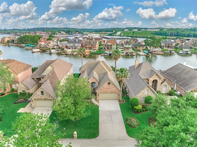 bird's eye view featuring a water view and a residential view