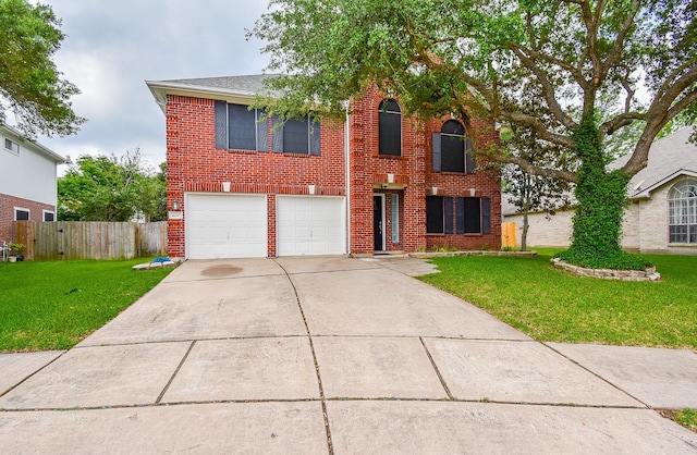 traditional-style home with concrete driveway, fence, a front yard, and a garage