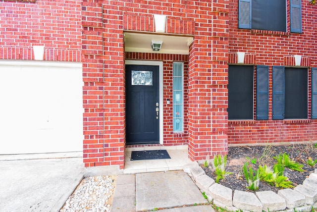 view of exterior entry with brick siding