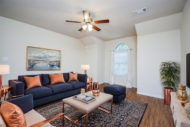 living room featuring visible vents, baseboards, ceiling fan, and wood finished floors