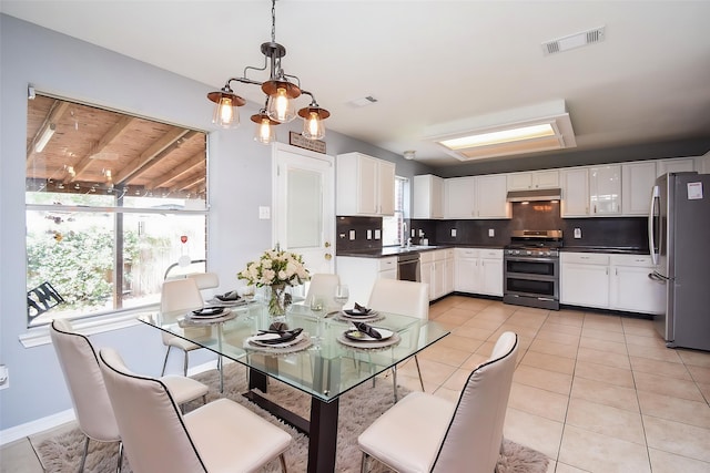 dining area featuring light tile patterned floors and visible vents