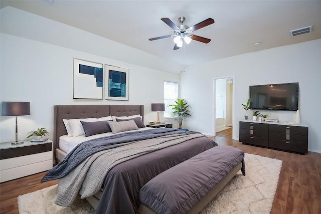 bedroom featuring ceiling fan, wood finished floors, and visible vents