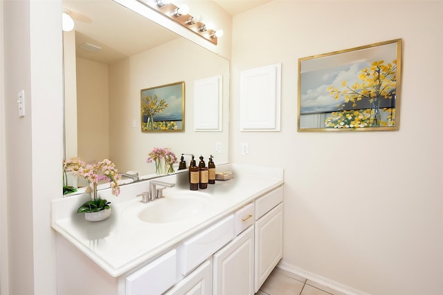 bathroom featuring vanity, baseboards, and tile patterned floors