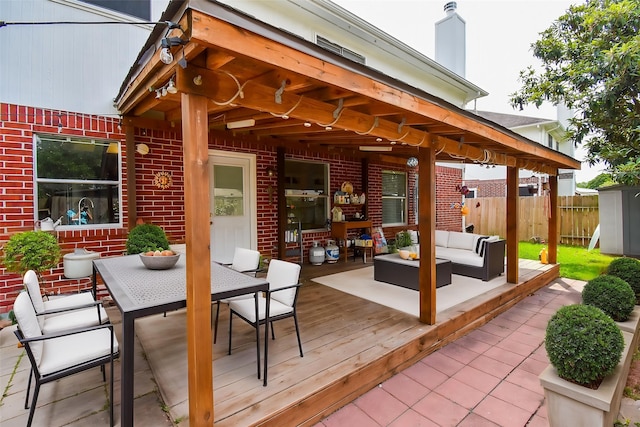 view of patio featuring fence, outdoor dining space, an outdoor living space, and a deck