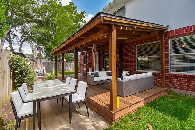 deck featuring an outdoor living space, a fenced backyard, and outdoor dining area